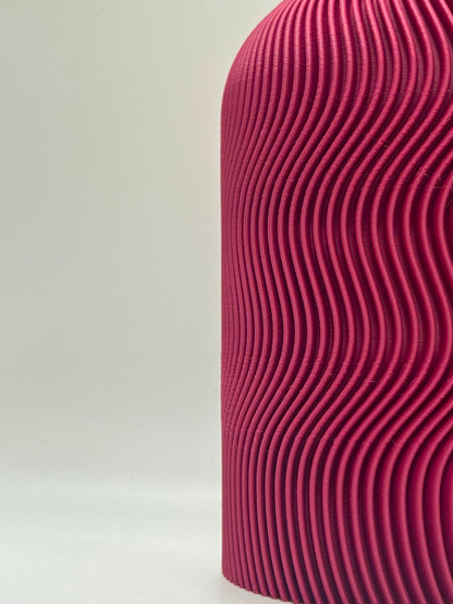 Close-up of a textured plum vase on a light gray background